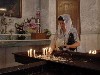 At a church (350Wx263H) - lighting candles on a Sunday prayers.  